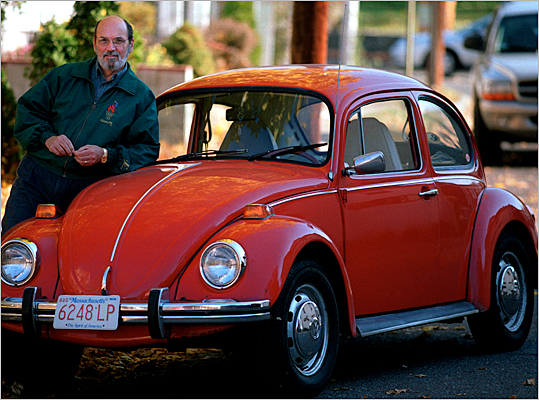 A 1973 Volkswagen Beetle with its owner
