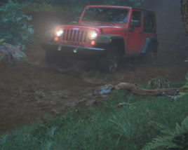 JEEP driving through muddy forest road